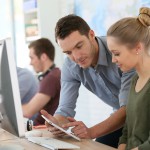 Student girl with trainer working on computer and tablet